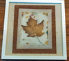 Handprinted maple leaf in white frame